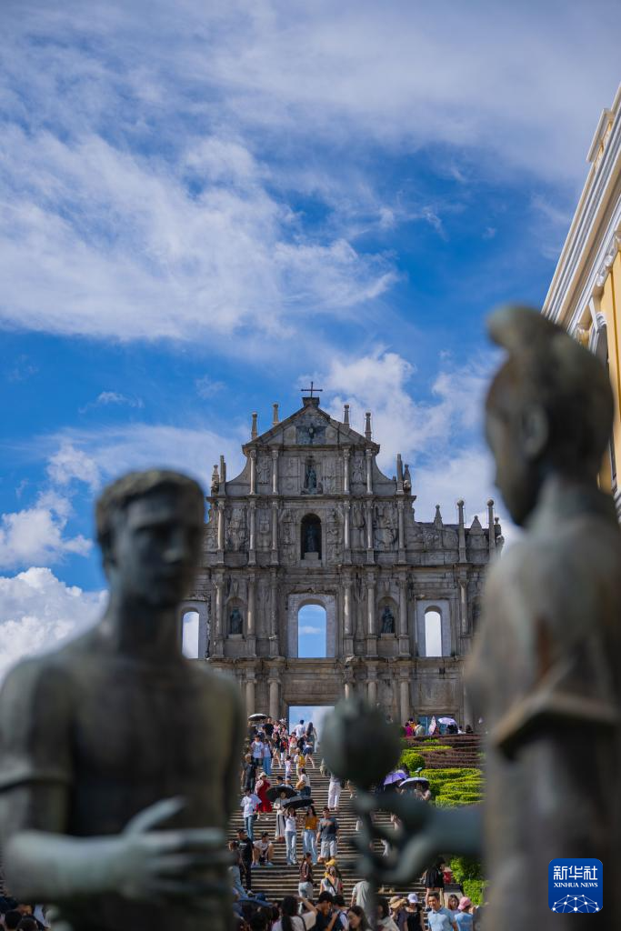 8月21日，旅客在澳门大三巴牌坊前游览。新华社发 （张金加摄）